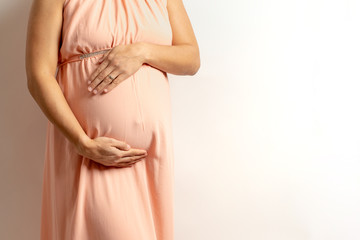 pregnant women holding her belly over an white background