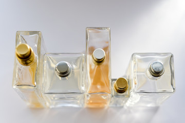 Women's perfume bottles in natural light, collection of perfume on a bathroom shelf