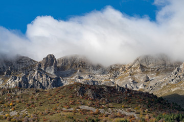Fog revealing the Alpine mountain range,  Italy