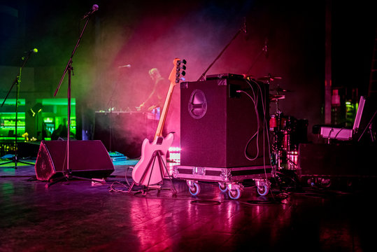 Stage With Gutar, Speakers And Smokes In Colorful Laser Lights