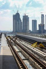 Fototapeta premium End of the subway line. In the background there are buildings under construction
