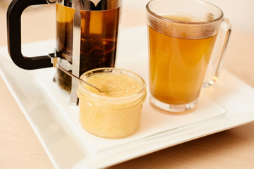 Tea with a teapot, cup and lemon jam. Natural fruit tea.