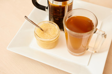 Tea with a teapot, cup and lemon jam. Natural fruit tea.