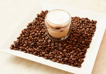 A cup of coffee in coffee beans. Coffee background
