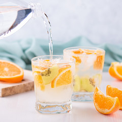Summer refreshing non alcoholic cocktails with orange and kiwi fruits closeup still life. Summer...