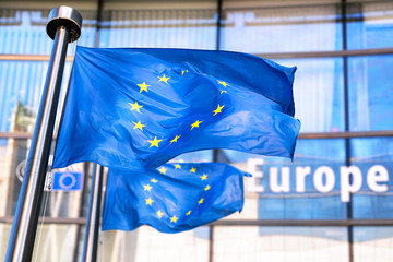 European Union flags waving in front of European Commission. - 319452445