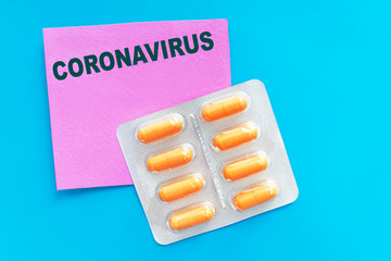 Text CORONAVIRUS nCoV  with orange pills, tablets in blister. Novel new Wuhan coronavirus disease from China, Pneumonia virus pandemic protection concept. Antidote, cure for disease, virus