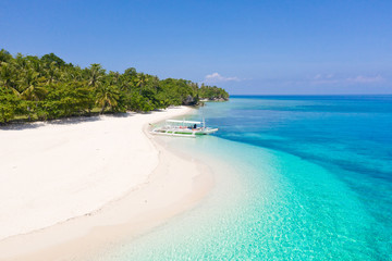 Tropical island with a white beach. Mahaba Island, Philippines.