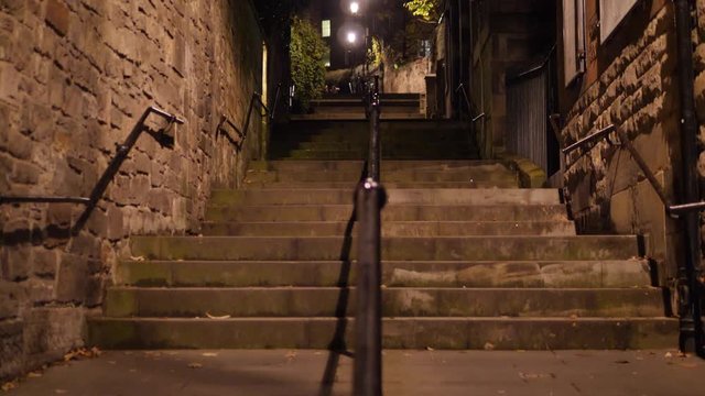 4K: View up The Vennel in Edinburgh, Scotland at night. Steps and stairs.