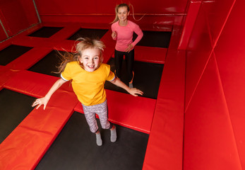 Happy family having fun while jumping on trampoline