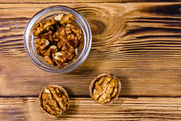 Cores of walnut in glass bowl on a wooden table. Top view
