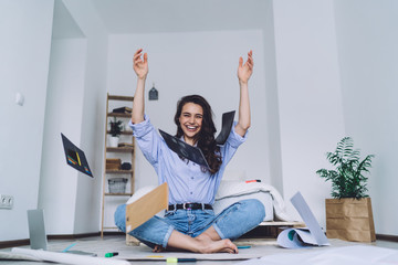 Young woman celebrating successful project at home