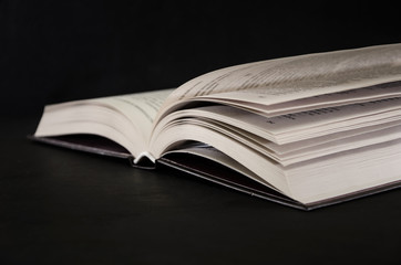 open book on a black background. Close-up.