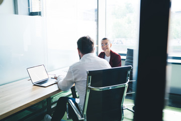 Businessman talking to applicant in office