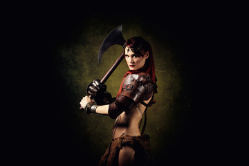 Portrait of a sexy warrior with an ax in her hands