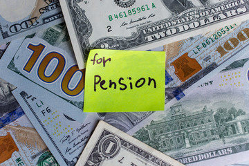 Yellow stick notes on an USD money background. Saving money for pension concept