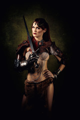 Portrait of a sexy warrior with a sword on her shoulder