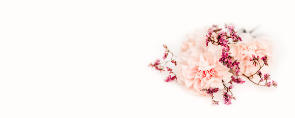 bouquet of flowers on the white background, symbol of love, pink or beije carnations and small decoration branch