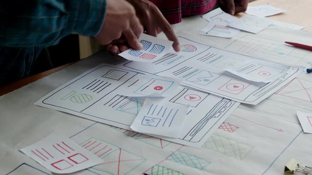 Web designer working laptop responsive design. Creative UI Ux designer teamwork meeting planning designing wireframe layout application development for smartphone screen mobile phone technology