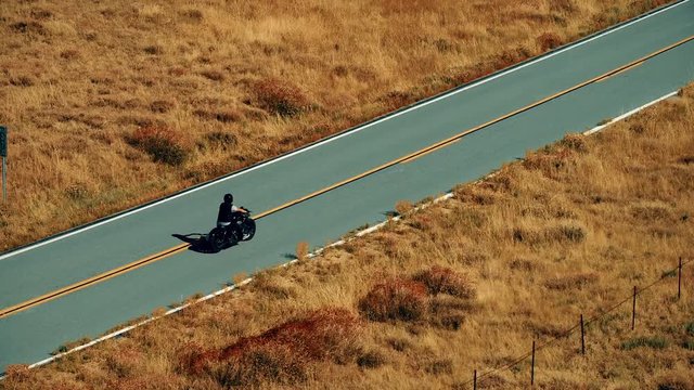 Aerial video of a lone motorcycle on an empty road in Cleveland National Forest in Southern California, USA
