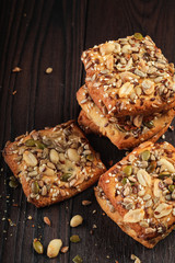 Closeup whole grain wheat scone with seeds on wooden background