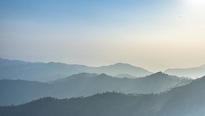 Green mountains in the fog. Seamless background. 