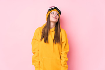 Young caucasian skier woman isolated dreaming of achieving goals and purposes