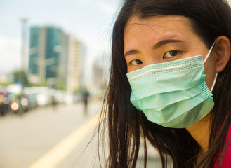 young beautiful and attractive Asian Chinese student woman walking on city street wearing...