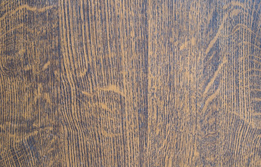 Black-brown wooden background with small splashes. Not a homogeneous wood texture.
