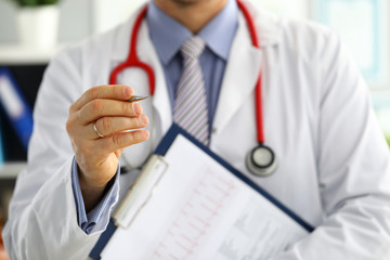 Male medicine doctor hands holding cardiogram chart