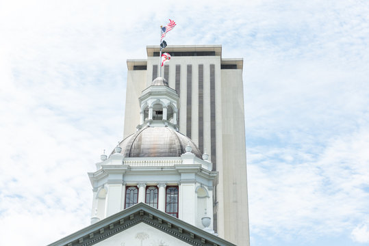 Tallahassee, USA - April 26, 2018: Exterior State Capitol Building In Florida During Sunny Day With Modern Architecture Of Government, Flags