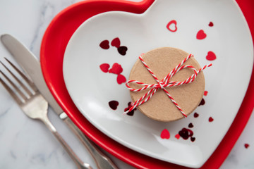 Valentine's day gift box with heart shaped plates and confetti