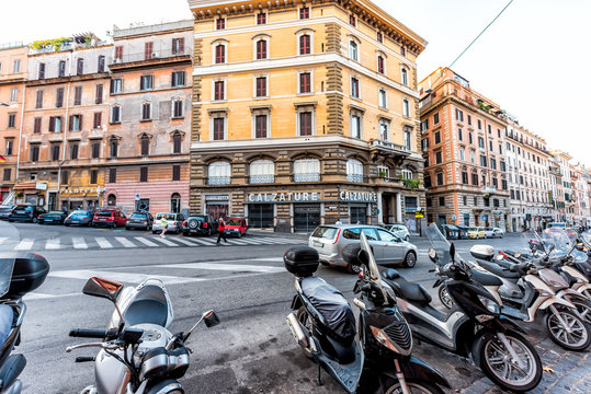 Rome, Italy - September 5, 2018: Italian street outside in historic city in morning wide angle road with nobody and parked motorcycle in Monti neighborhood