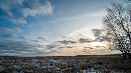 Beautiful setting sun over frozen field