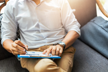 Businessman hold pen and working calculate data. document graph chart and report marketing. Business office concept.