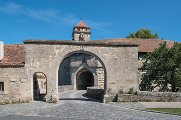 Fototapeta na wymiar Rothenburg ob der Tauber, Germany - July 23, 2019; City gate called Spiraltor an medieval gate and a tourist atraction in the touristic town Rothenburg on the romantic road in Bavaria