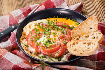 Homemade breakfast fried egg with tomato.