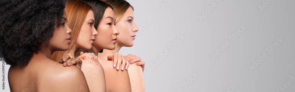 Wall mural Diverse women touching naked shoulders