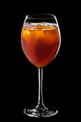 Wine glass with mixed beer, tonic and coffee cocktail isolated on black