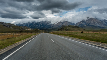 Asphalt road heading into a mountains