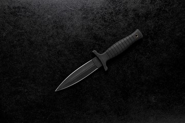 Closeup shot of a fixed sharp knife on a black background