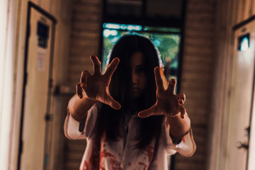 Fototapeta na wymiar Halloween girl with scary hand in Abandoned house.