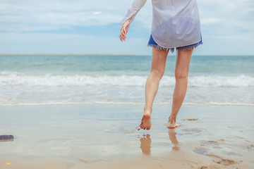 Young woman running playful on tropical beach  in freedom.