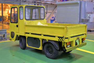 A small electric car for transporting goods and moving around the factory and workshops