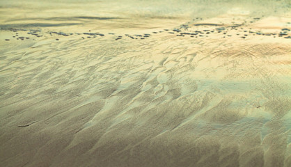 Sea water and shiny coastal sand, abstract photo