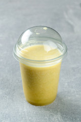 mango banana fresh juice in a plastic take-away glass