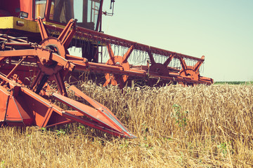 Closeup of harvesting machinery detail while working the field.