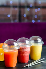 set three smoothies and fresh juices in a take-out glass
