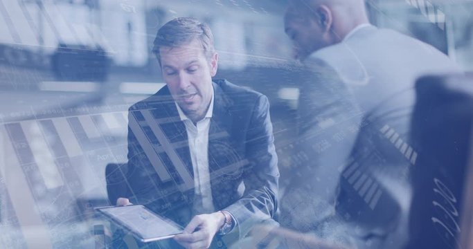 Digital composite of diverse business people in a meeting in office using digital tablet with graphics moving over the screen