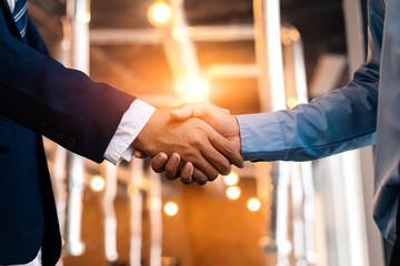 Business shaking hands, finishing up meeting. Successful businessmen handshaking after good deal.
